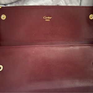 Cartier Deep Red Leather Waller with Gold Accents.